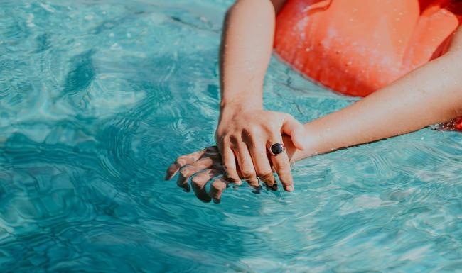 woman relaxes on a floatie in swimming pool