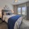 a bedroom with a bed and a fan