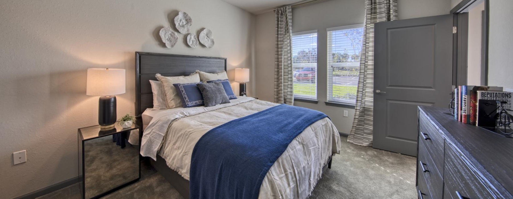 a bedroom with a bed and a fan